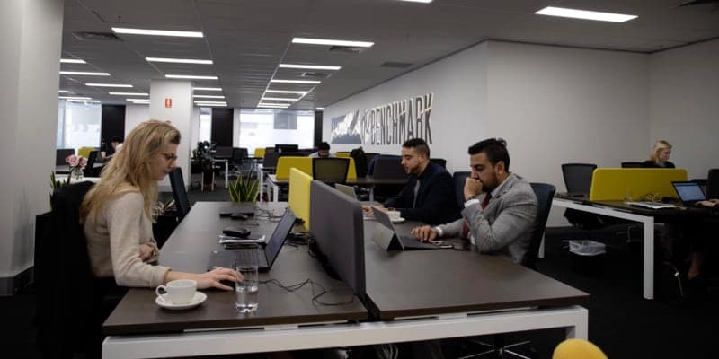 Coworking floor with shared desks and collaborative modern office ambiance