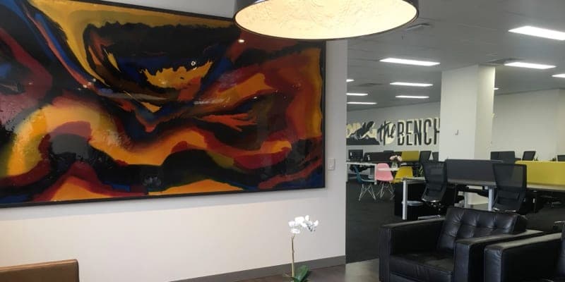 Welcoming office waiting area with reception desk and professional branding